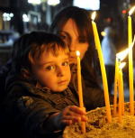 Child lighting candles